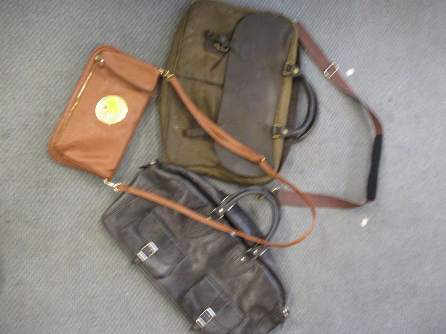 A Barbour gents wax and leather Tarras bag together with a ladies shoulder bag in mid brown leather,