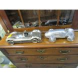 A Libra Distinctive Interiors metal model of a vintage two-seater car, along with a similar model of