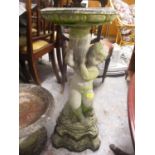 A garden stoneware bird bath in the form of a figure holding a vase, 30" h