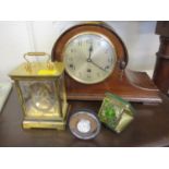 A mahogany cased mantle clock, together with a mid 20th century travel clock, a white metal dressing