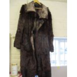 A brown rabbit fur coat with soft leather interior which is reversible to wear (Condition: some worn