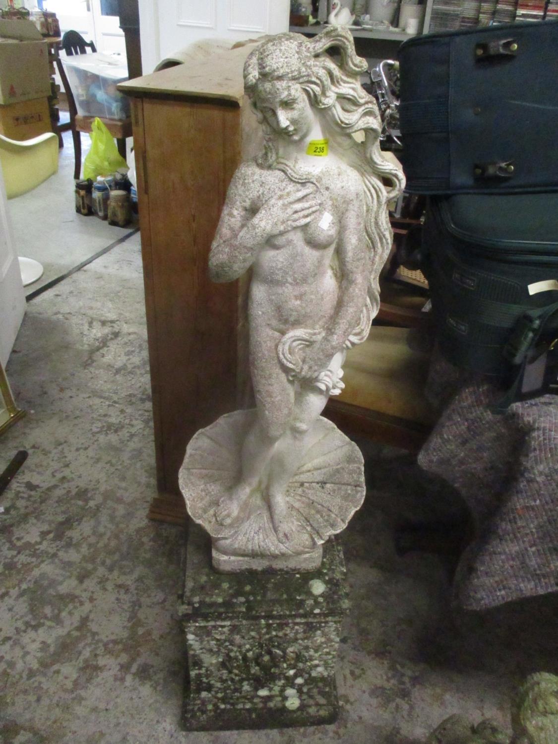 A garden stoneware statue of a nude female on a raised plinth, 49 3/4"h