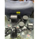A Praktica B100 electronic in case with additional lens and accessories in camera case