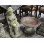 A garden stoneware statue of a seated female, together with a small bird bath