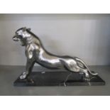 A contemporary metal sculpture of a puma mounted on a black variegated marble base, unsigned, base