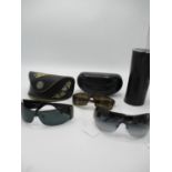 Three pairs of sunglasses comprising a pair of Gucci tortoiseshell effect unisex glasses, a pair