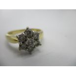 A seven stone diamond ring fashioned as a flower in a white metal and 18ct gold setting, London