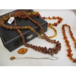 A quantity of strung amber bead necklaces and other amber items