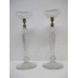 A pair of early 20th century glass candlesticks, each with a Cricklite Clarks patent night light