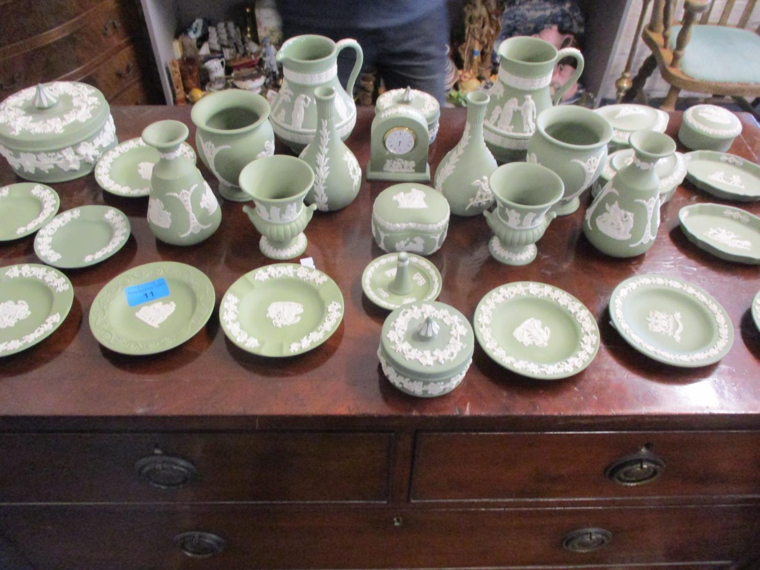 A quantity of Wedgwood green Jasperware ornaments to include a small clock