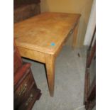A late Victorian pine table with single frieze drawer having brass handle on square, tapering legs