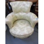 A floral upholstered low armchair
