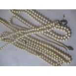 Five pearl necklaces to include one having a 9ct gold clasp and inset with turquoise