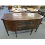 A late Victorian/early Edwardian Sheraton revival bow front sideboard with two long drawers, flanked