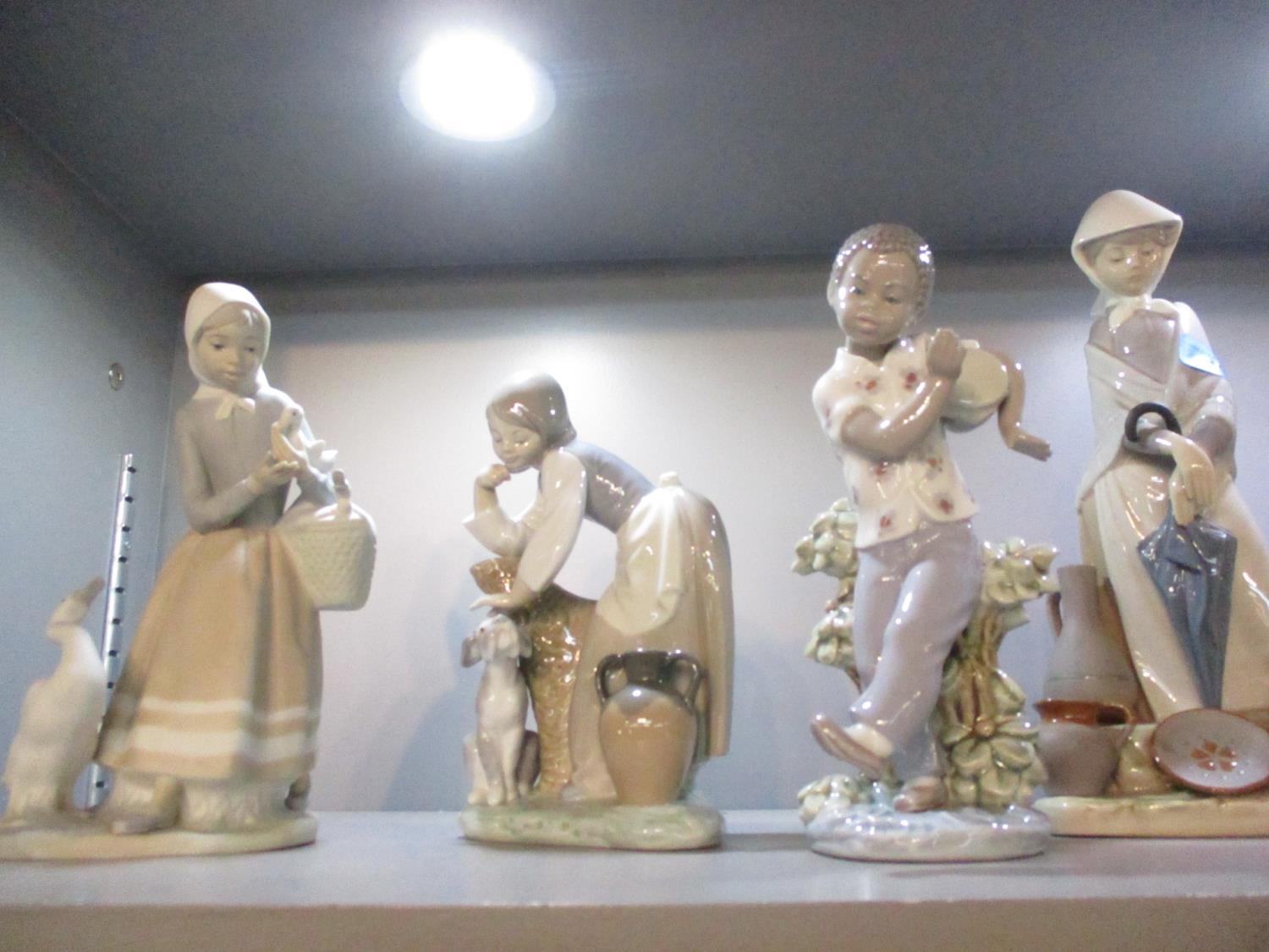 Seven Lladro figures to include a young boy playing a drum - Image 3 of 3