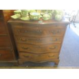 A reproduction serpentine small chest of drawers having a brush slide and four graduated drawers, 31