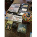 A mixed lot to include a collection of phone cards mounted in two albums, various postcards, a tin