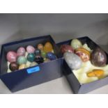 A collection of onyx and semi precious stone ornamental eggs and a semi precious ornamental stone