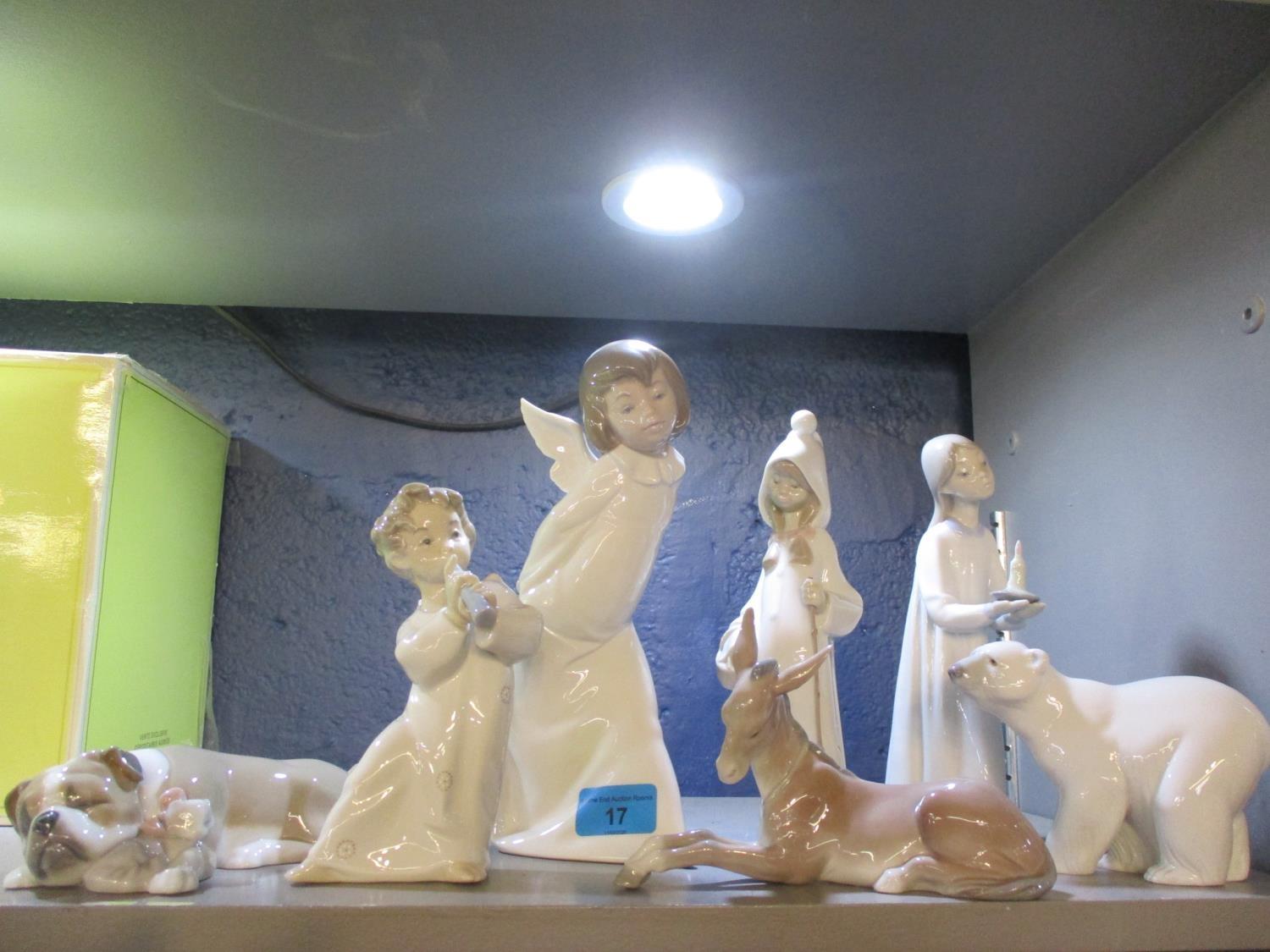 Four Lladro figures and three Lladro models of animals to include a polar bear and a bulldog