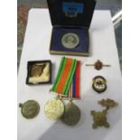 A WWII Campaign Defence medal and War medal, along with other medals and badges