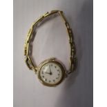 An early 20th century 9ct gold cased ladies wrist watch, white enamel face with Arabic numerals