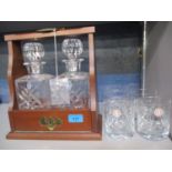 A modern mahogany Tantalus with two Royal Doulton glass decanters, together with four Royal Albert