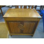 An early 20th century oak coal/log box with a crest the front, 22" h x 22"w