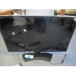 An LG 27" flatscreen television, on stand with remote