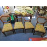 A set of four Victorian mahogany balloon back chairs with upholstered seats