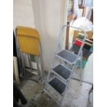 A pair of folding kitchen stools and folding steps