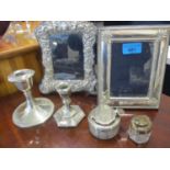 Two silver photo frames, two silver dwarf candlesticks and two silver topped and glass ink pots