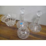 Four pieces of glassware to include a pair of ships decanters