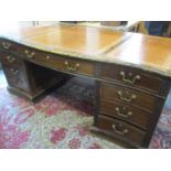 A mahogany partners twin pedestal desk with brown scriber