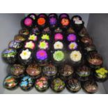 Approximately 100 hand made and painted soaps in the form of various flowers, contained in lacquered