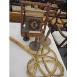 A needlepoint work frame enclosing a woollen carpet sample, together with three vintage treen spools