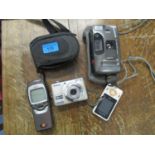 A Nikon Coolpix digital camera, an Olympus Trip MD2 camera, Nokia vintage mobile phone and one other
