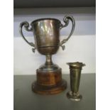 A silver trophy cup with scrolled acanthus leaf and dolphin terminal twin handles, engraved Golf