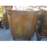 A radiogram in a mahogany bow fronted case, in the form of a side cabinet