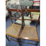 An Edwardian open armchair and two side chairs with cane seats