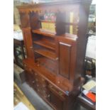 A modern Stewart Linford oak dresser having a plate rack above cupboards and drawers, 76"h x 58 1/