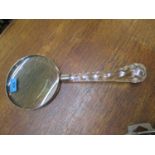 A modern large magnifying glass with glass faceted handle