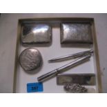 Two silver cigarette cases, one monogrammed and the other engraved, a white metal engraved compact