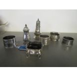 Mixed group of silver items to include a silver pepperette, four napkin rings of mixed dates and