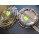 A large quantity of catering stainless steel platters, mainly oval in shape