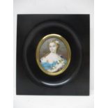 19th Century French School - a half length portrait miniature of a woman with flowers in her long