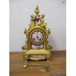 A late 19th century French gilt spelter cased mantle clock with porcelain panels and dial