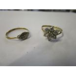 An 18ct yellow gold and platinum ring set with a single diamond chip and a 9ct yellow gold daisy