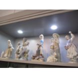 Seven Lladro figures to include a young boy playing a drum