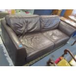 A large brown leather three seater sofa