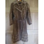 A 1970s ladies faux fur and brown leather, full length coat, 42" long x 36/38" chest approximately